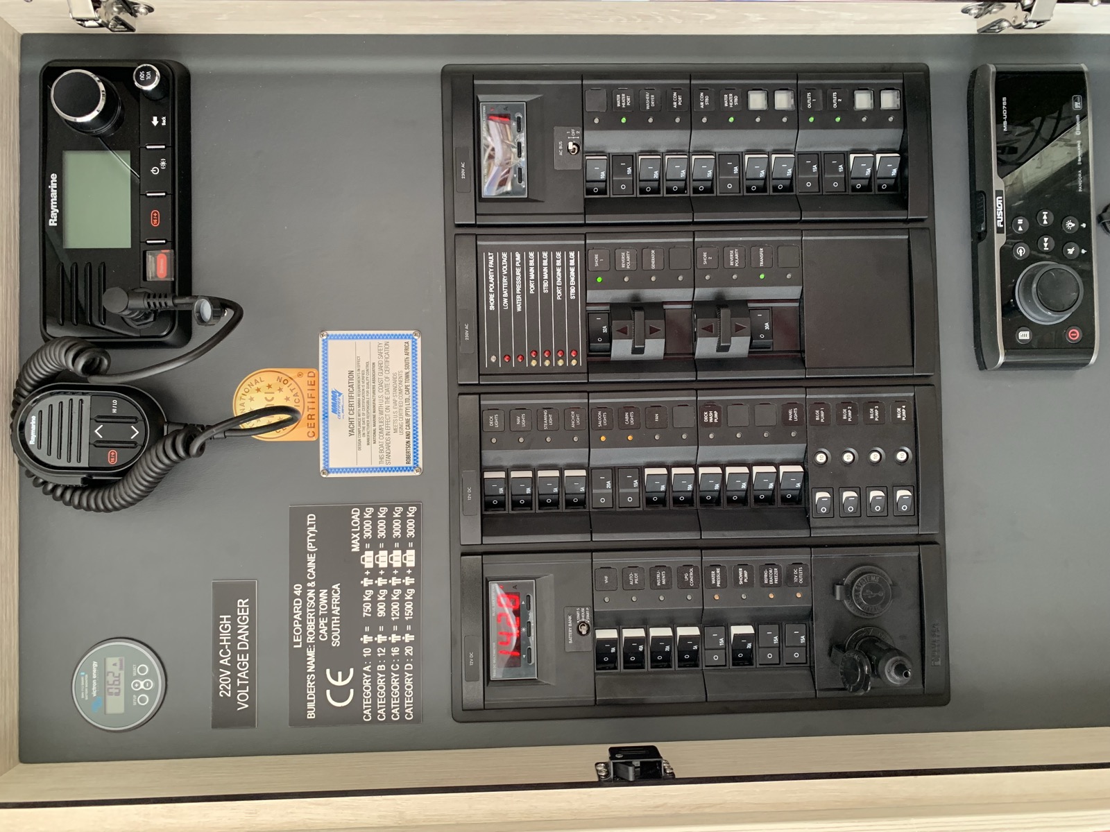 The completed electrical panel — circuit breakers, VHF radio, and chartplotter all in place