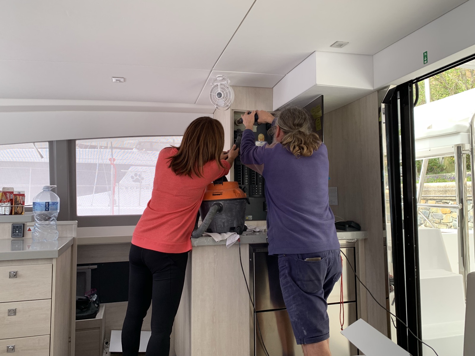 Yuka and a technician working on the interior electrical installation