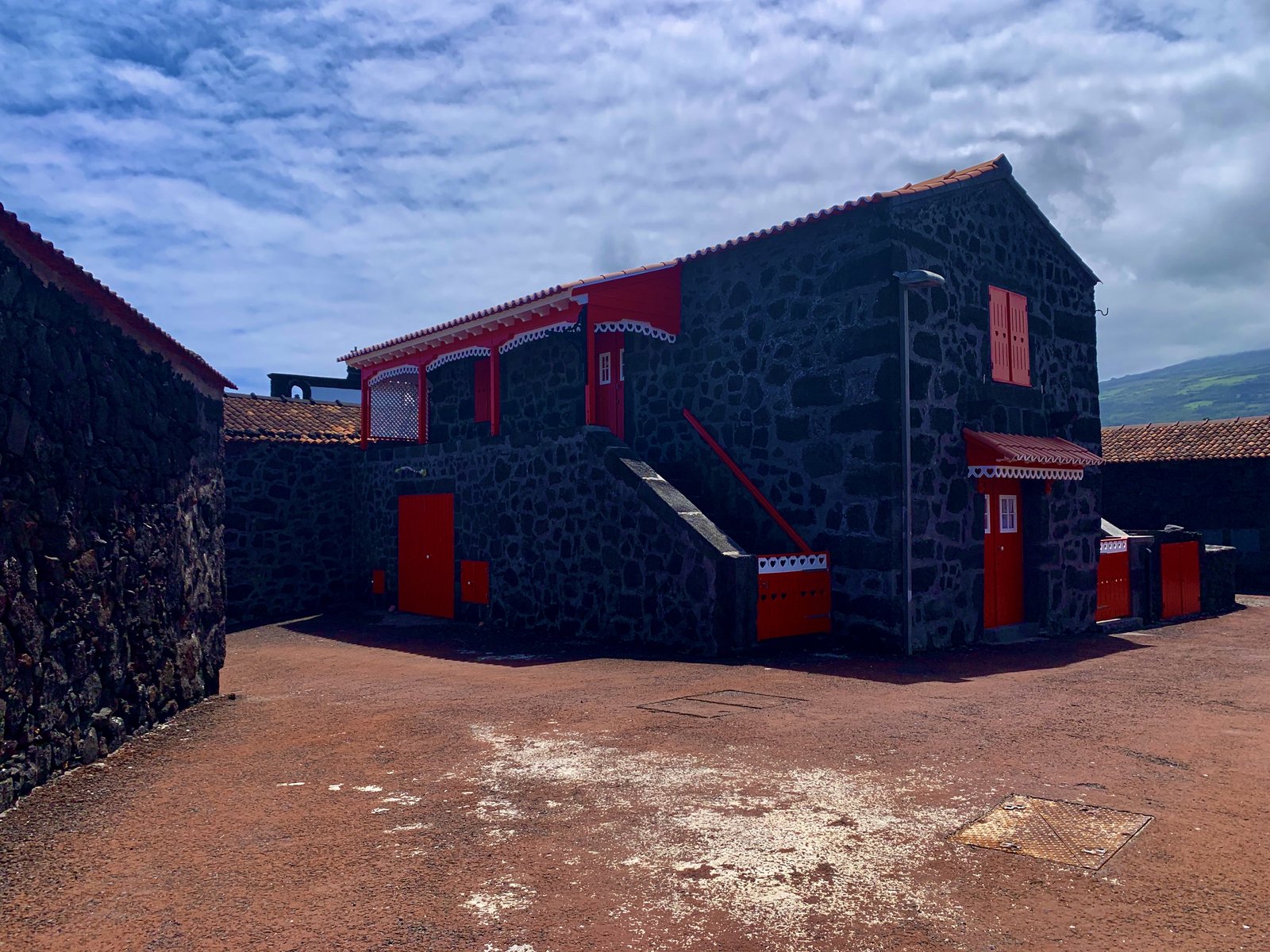 Pico island winery — black lava stone, red doors, not a straight line anywhere.