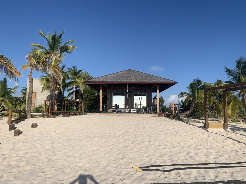 An open-air beach pavilion on Barbuda's white sand — our gym during the lockdown months