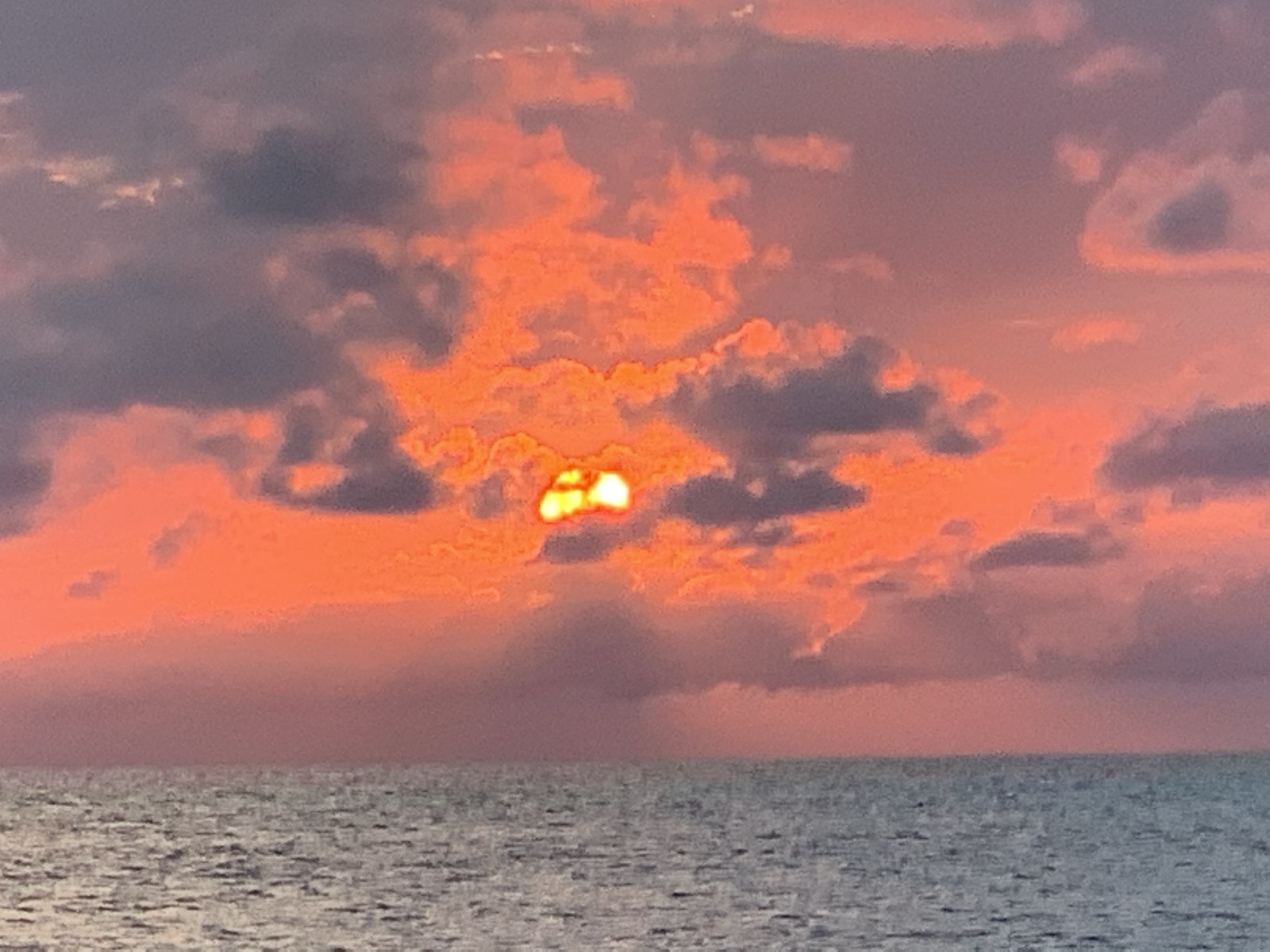 Sunset over the Atlantic from Barbuda — brilliant orange and pink