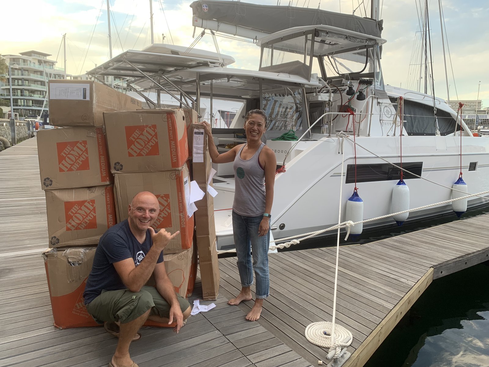 Francesco and Yuka reunited with the boxes on the Cape Grace dock — Oroboro waiting behind them