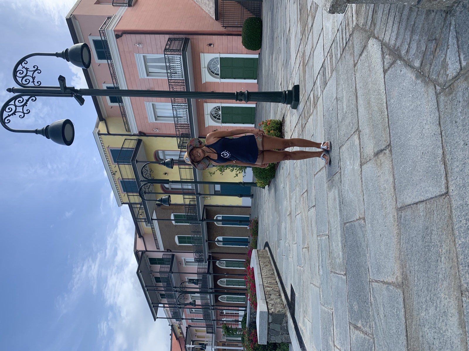 Yuka at the Canouan marina grounds with the colonial resort buildings behind her — two days after Gonzalo