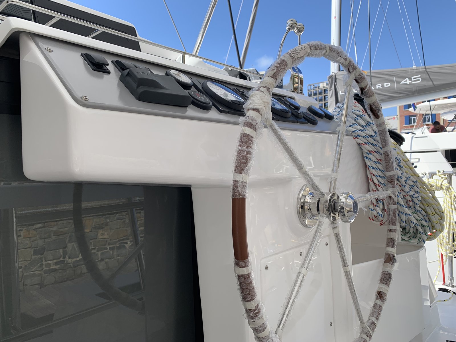 The helm — wheel, winches, and sail controls