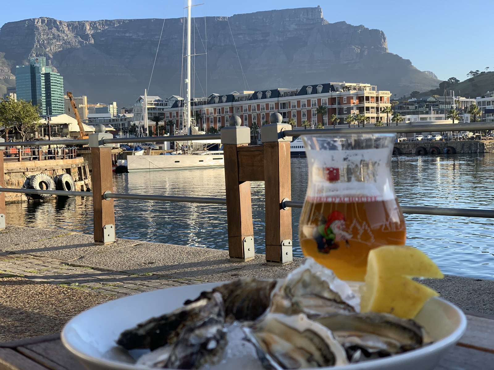 Oysters and Belgian beer at a waterfront restaurant, Table Mountain behind