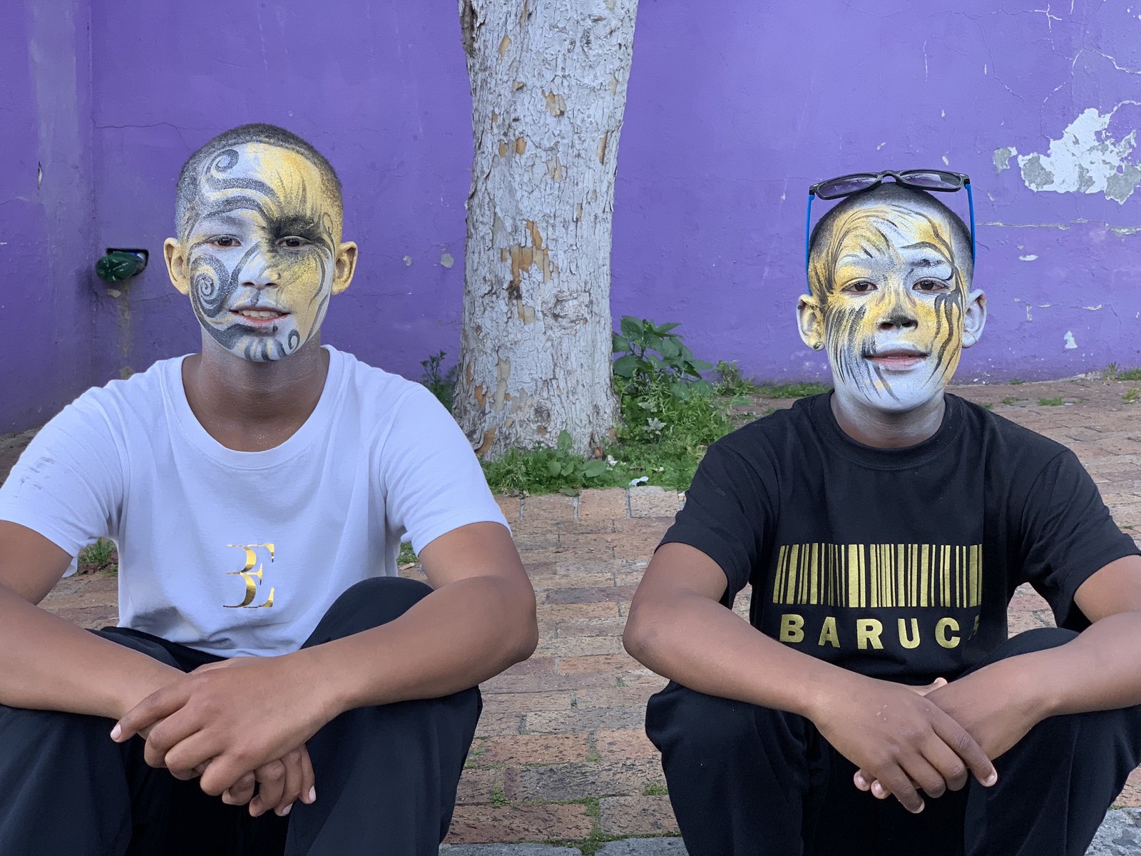 Two young men with elaborate face paint at the Bo-Kaap festival
