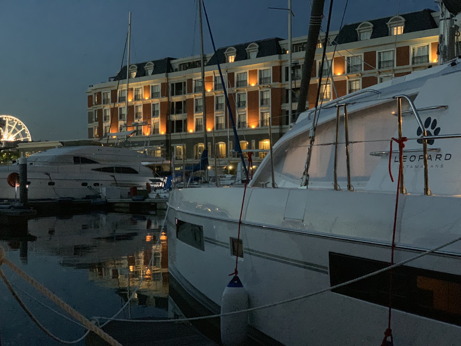 Oroboro at Cape Grace at dusk, the hotel glowing behind her