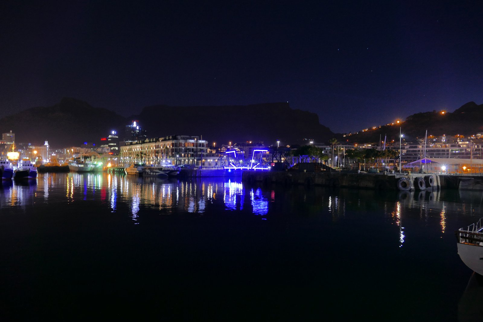 The V&amp;A Waterfront swing bridge lit blue at night