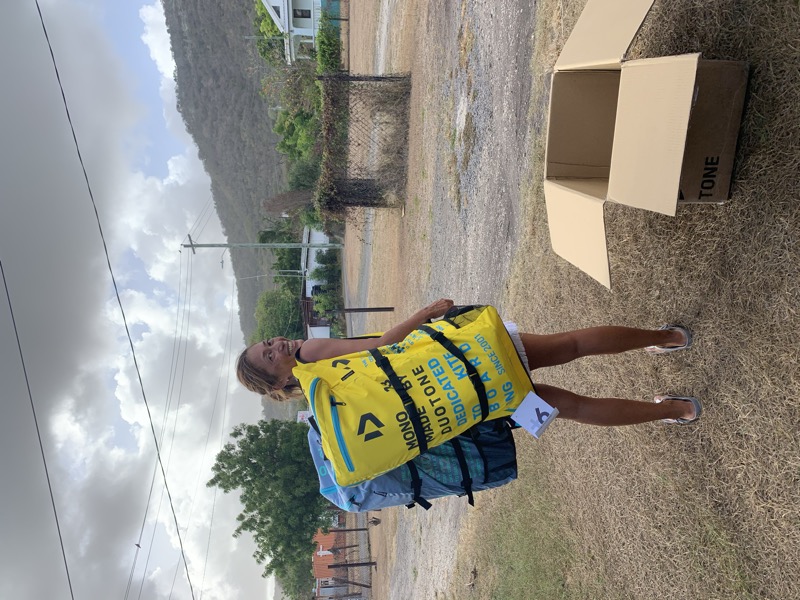 Yuka carrying a new Duotone kite bag — fresh kite day!