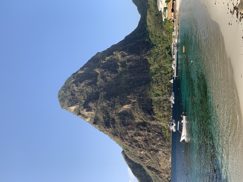 The iconic Piton volcanic peak in St Lucia rising above sailboats anchored at its base