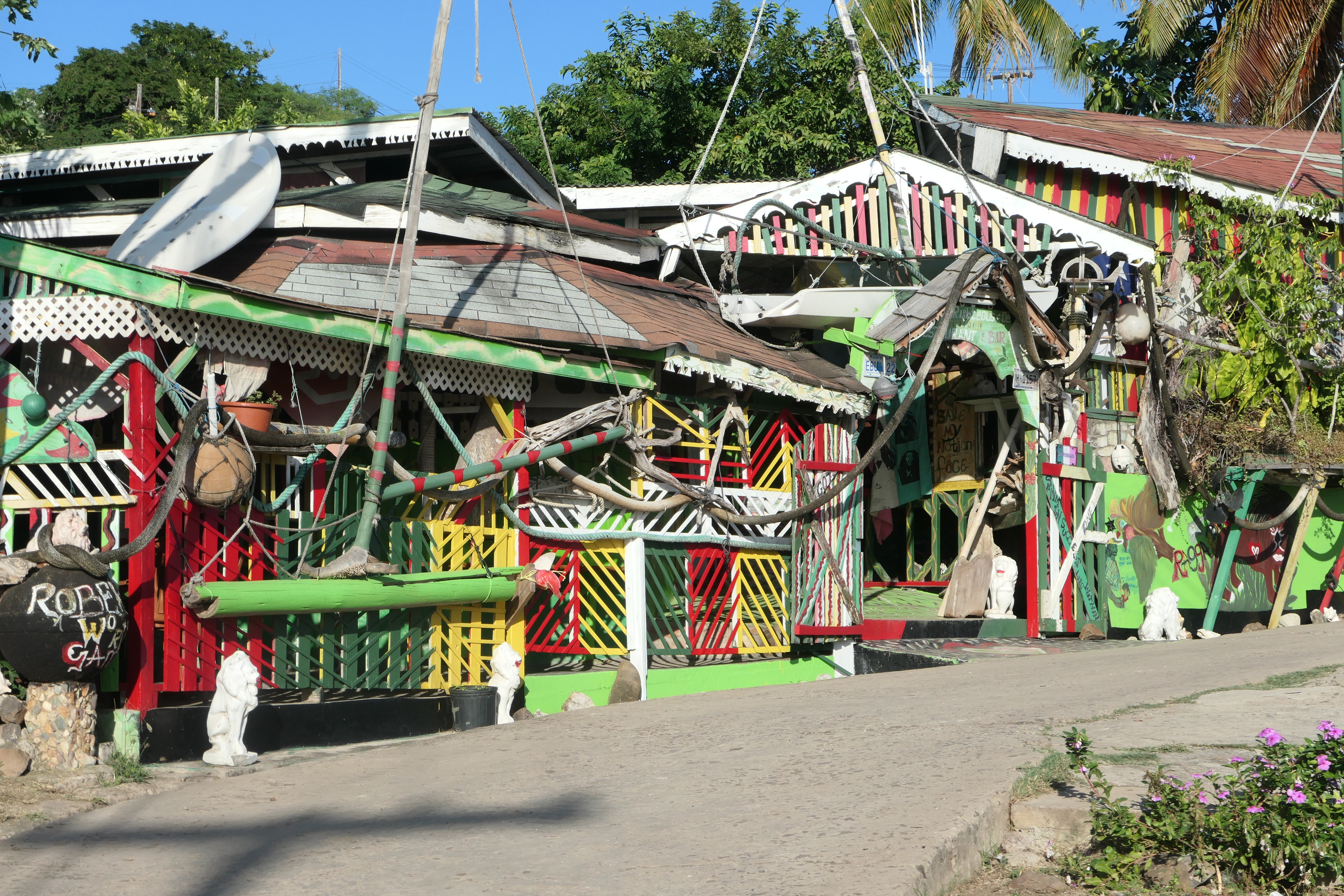 A colorful rasta-themed bar exterior with eclectic decor in the Grenadines