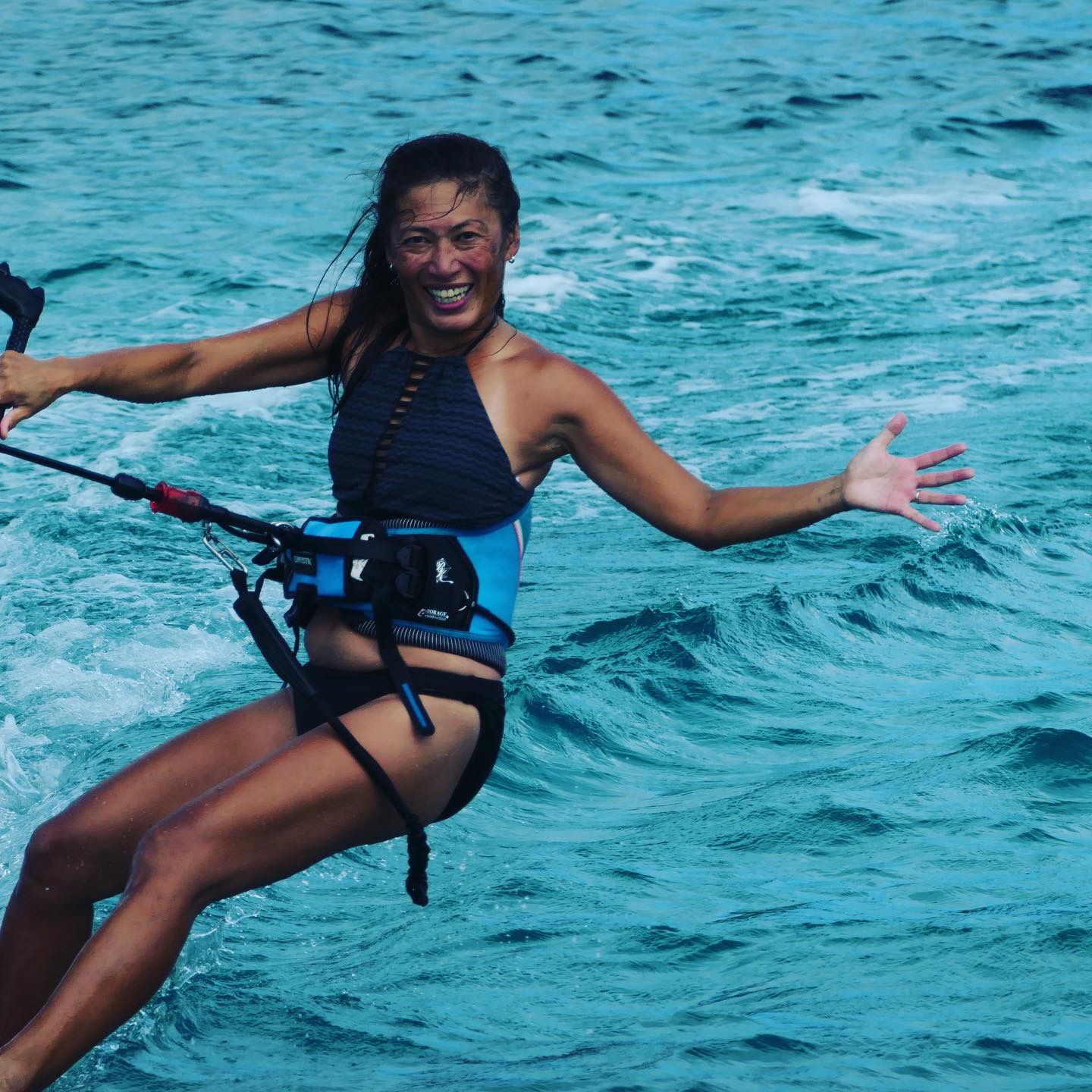 Yuka kiteboarding — all smiles in the turquoise water