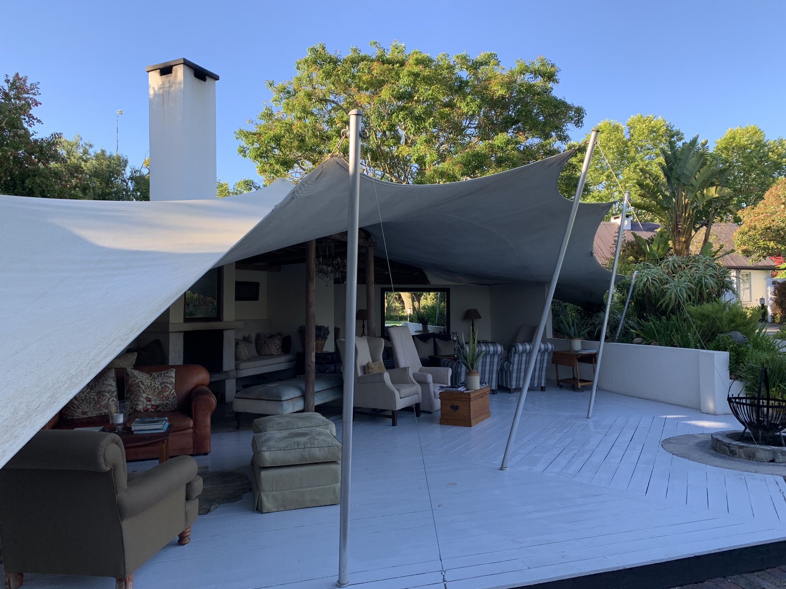 The outdoor lounge terrace at the lodge, shaded by sail awnings