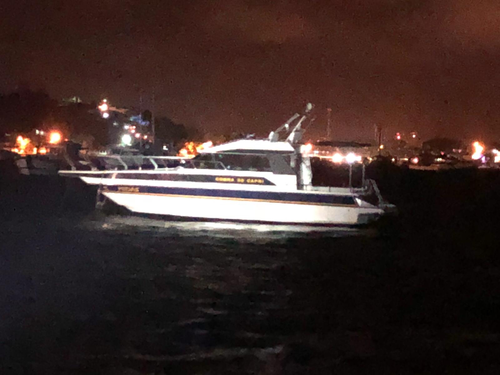 Boat drifting in the anchorage at night