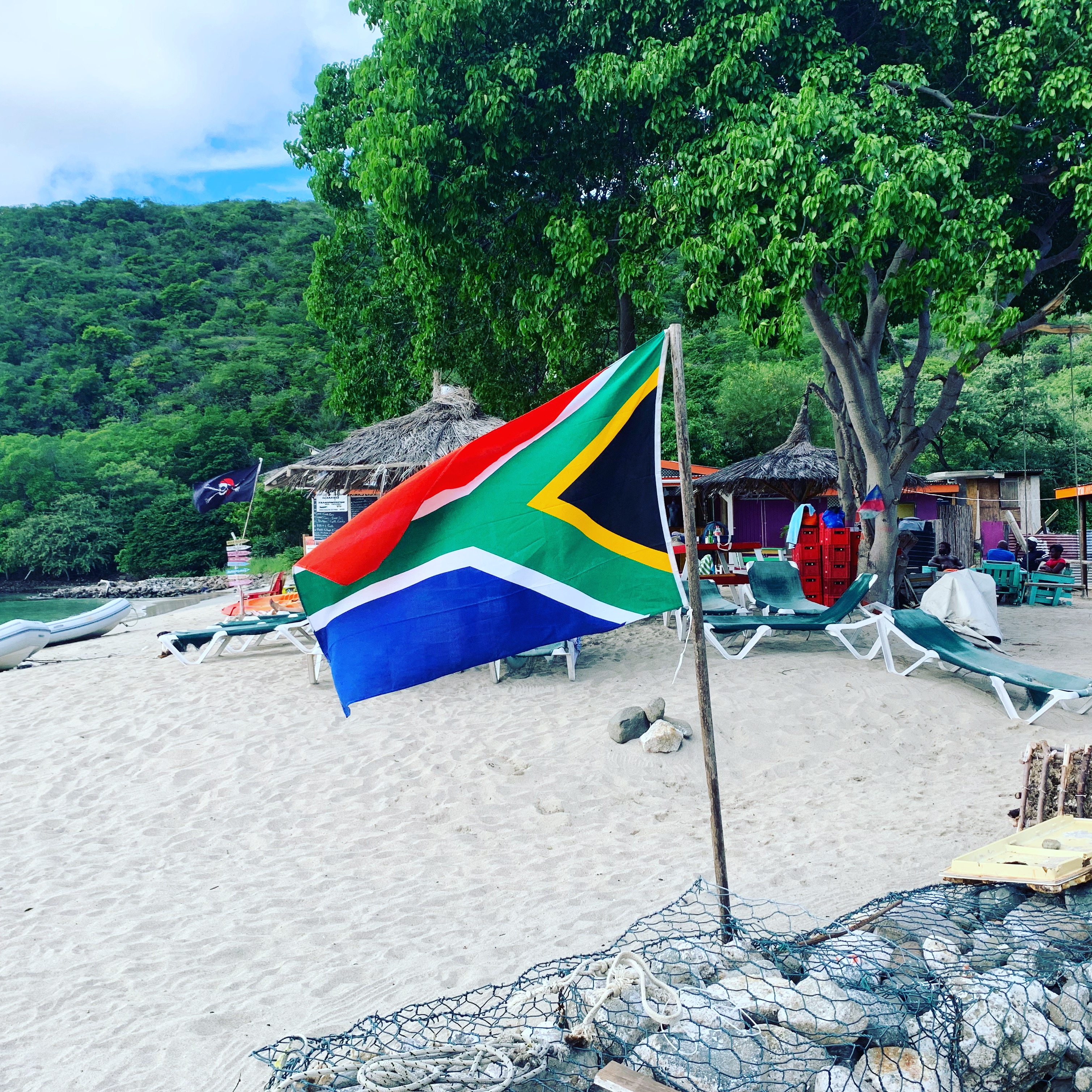 A South African flag flying on a Carriacou beach — sailors come from everywhere