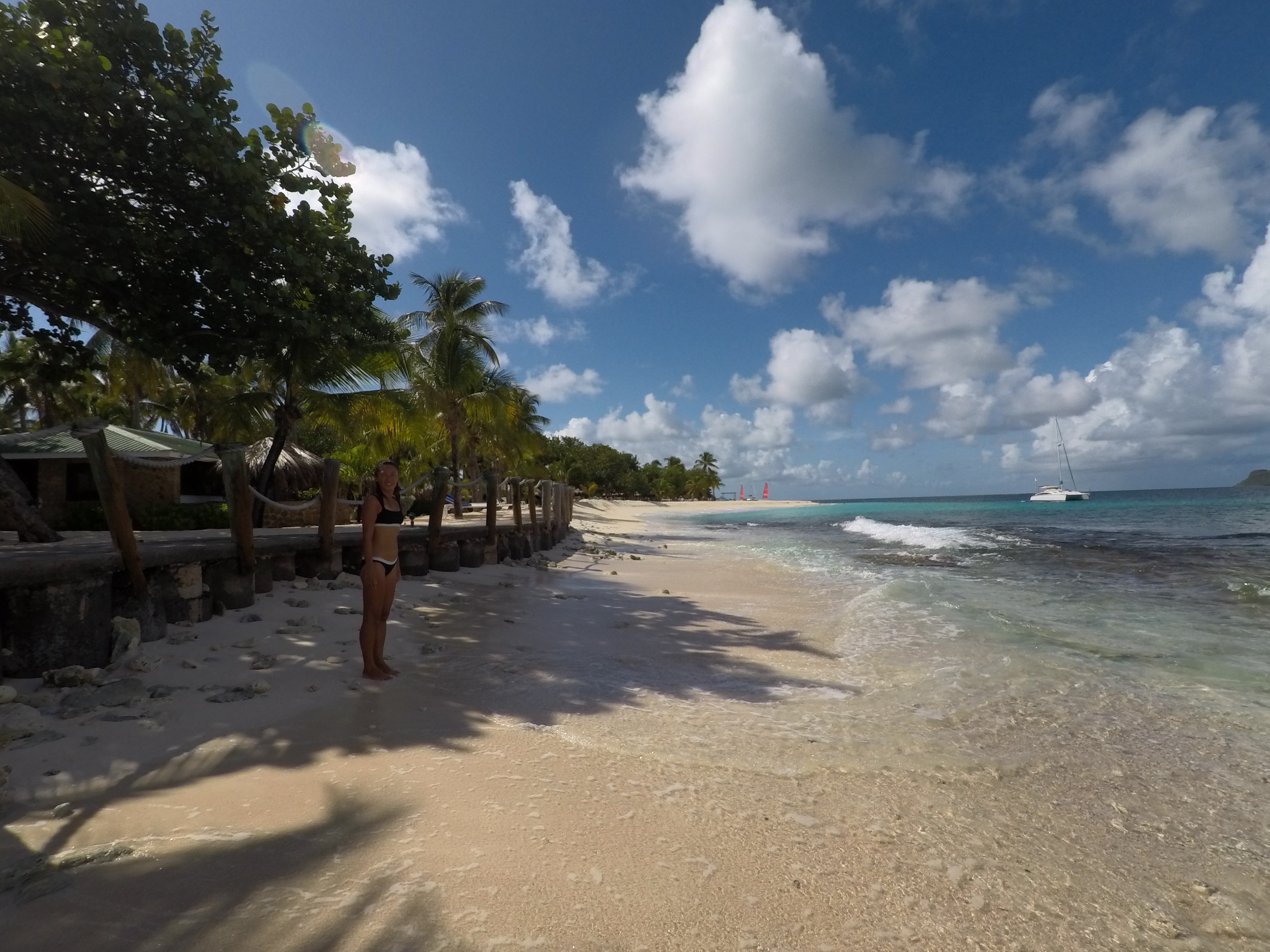Yuka on the beach — Oroboro anchored just offshore