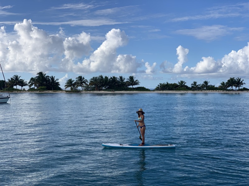 Yuka on the paddleboard with Carriacou's sandbar island behind her