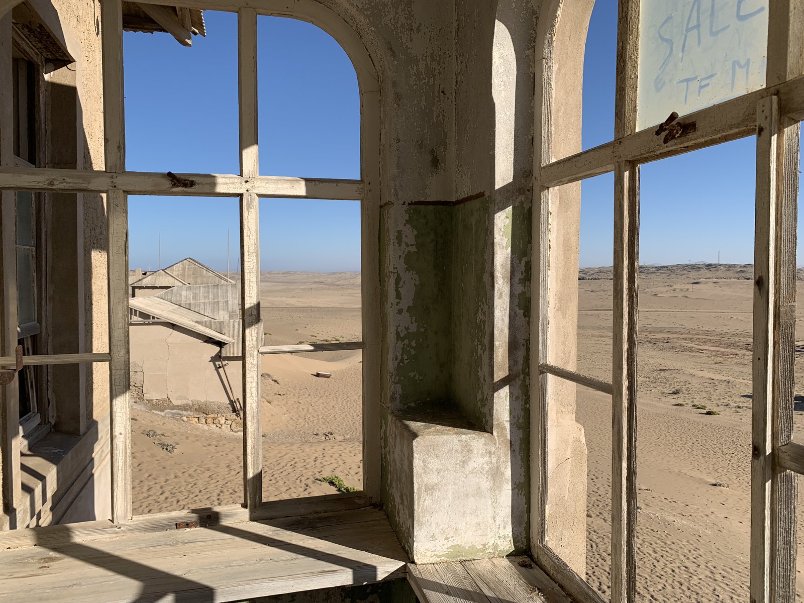 Looking through a Kolmanskop window into the Namib Desert