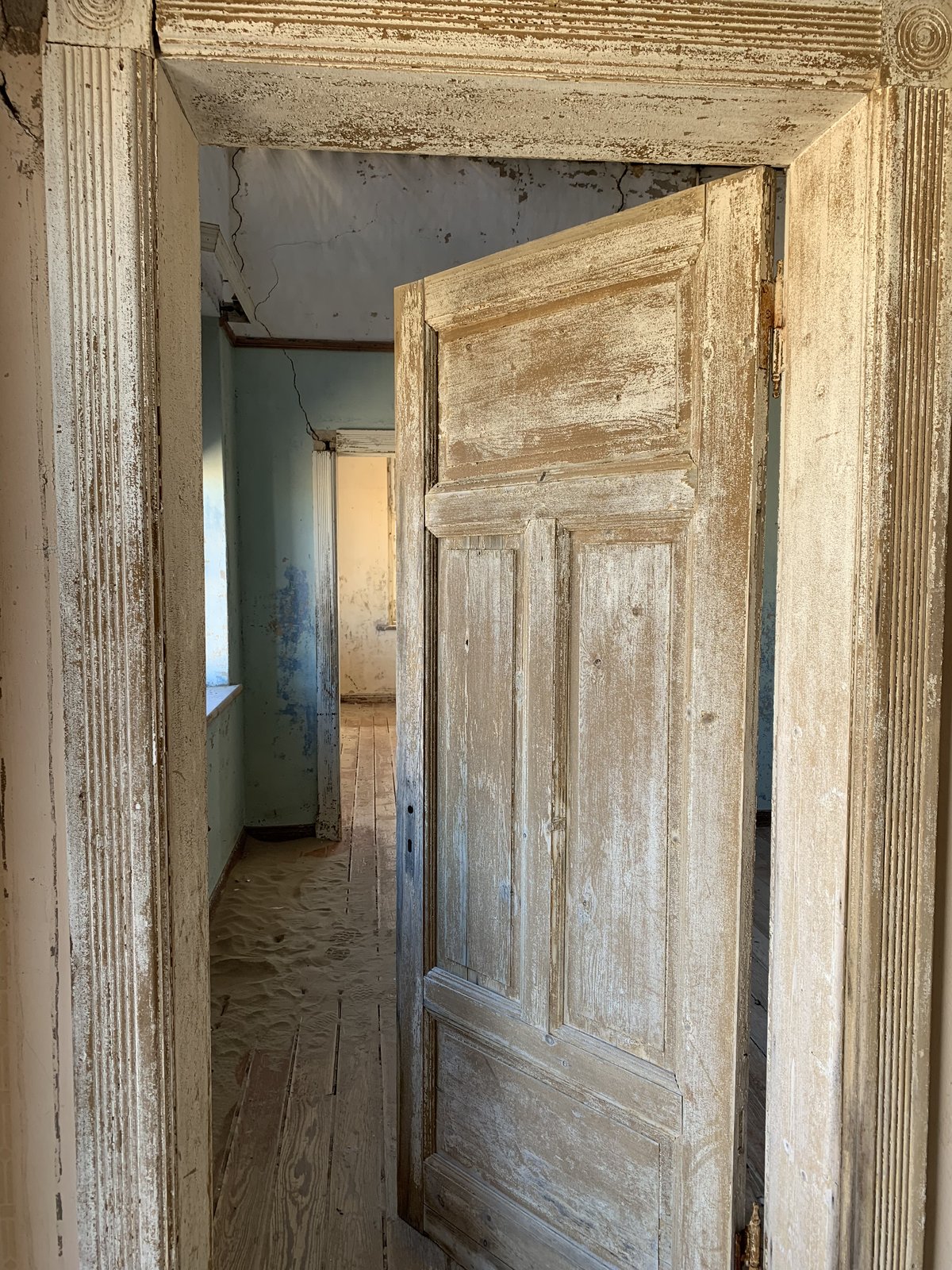 Inside one of Kolmanskop's sand-filled rooms