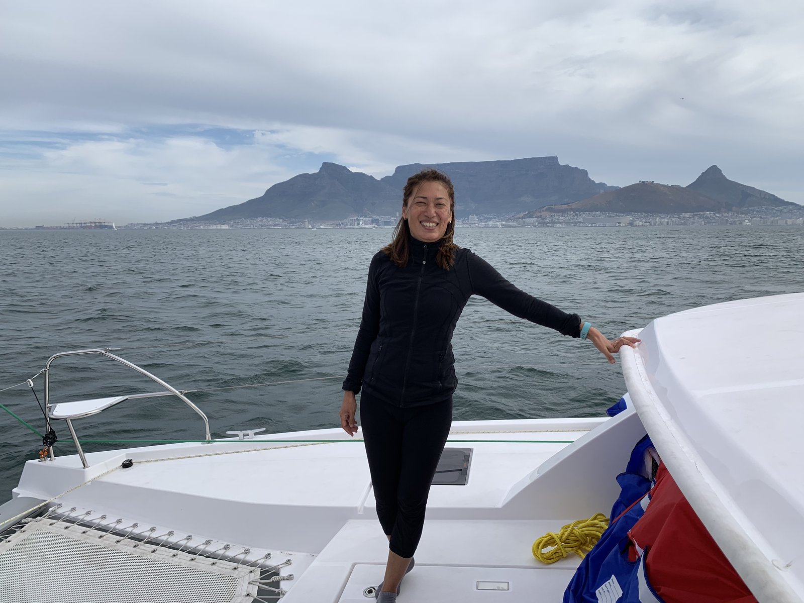 Yuka on the foredeck during the sea trial — Table Mountain rising behind her