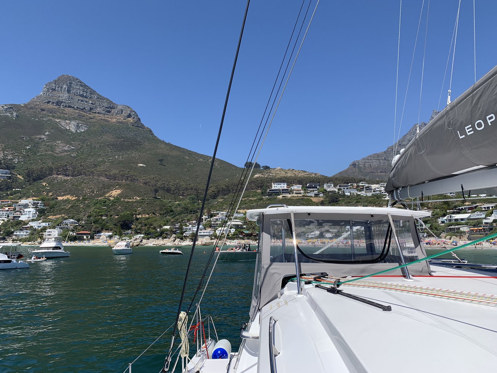 Oroboro at anchor off Camps Bay, Lion's Head mountain rising behind