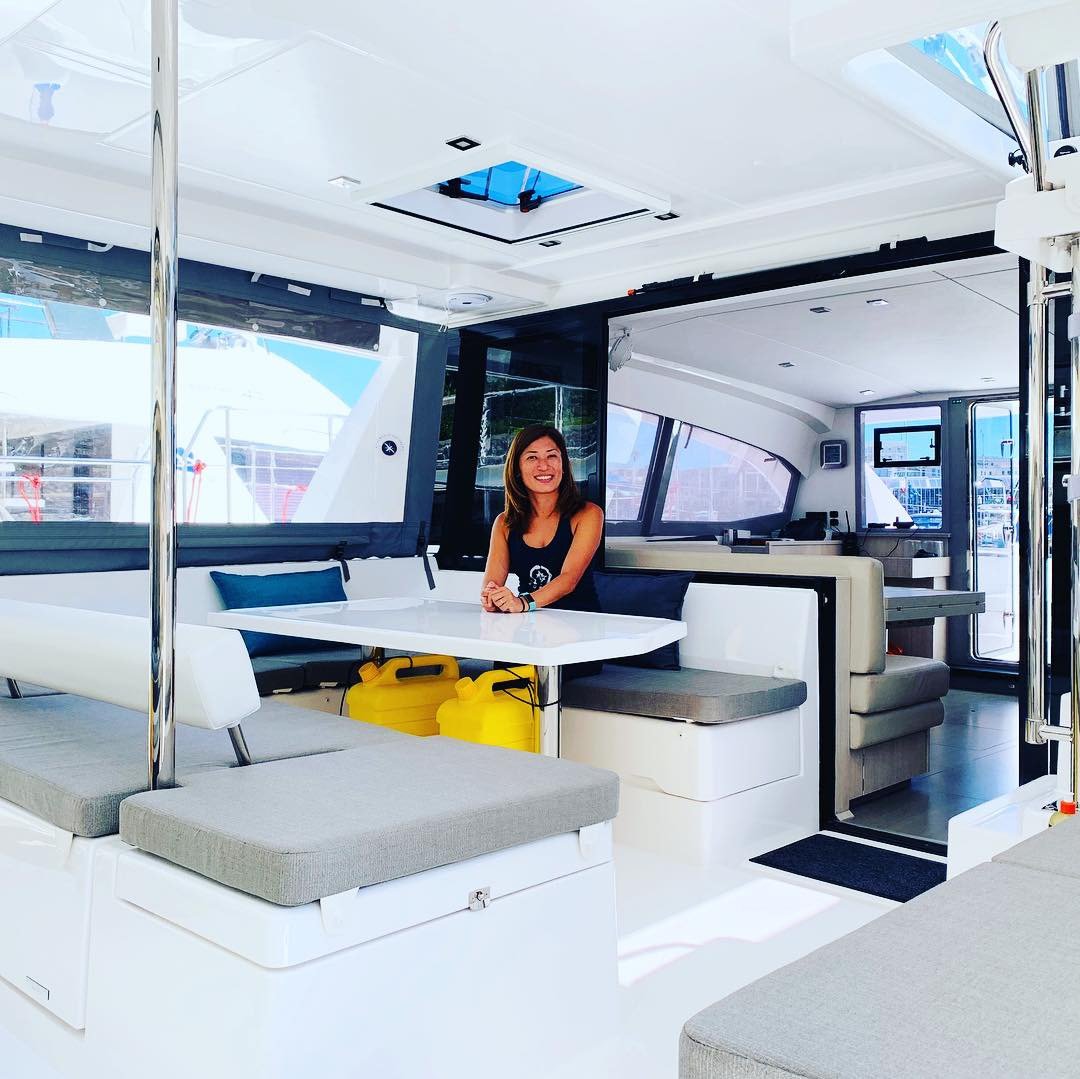 Yuka at the saloon table — the heart of the boat