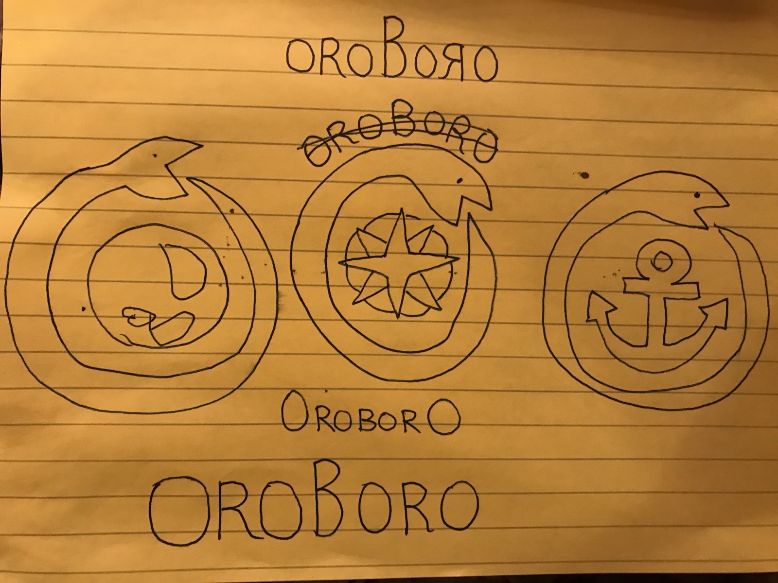 Yuka's hand-drawn logo sketches — three ouroboros circle variations and lettering experiments for the Oroboro name