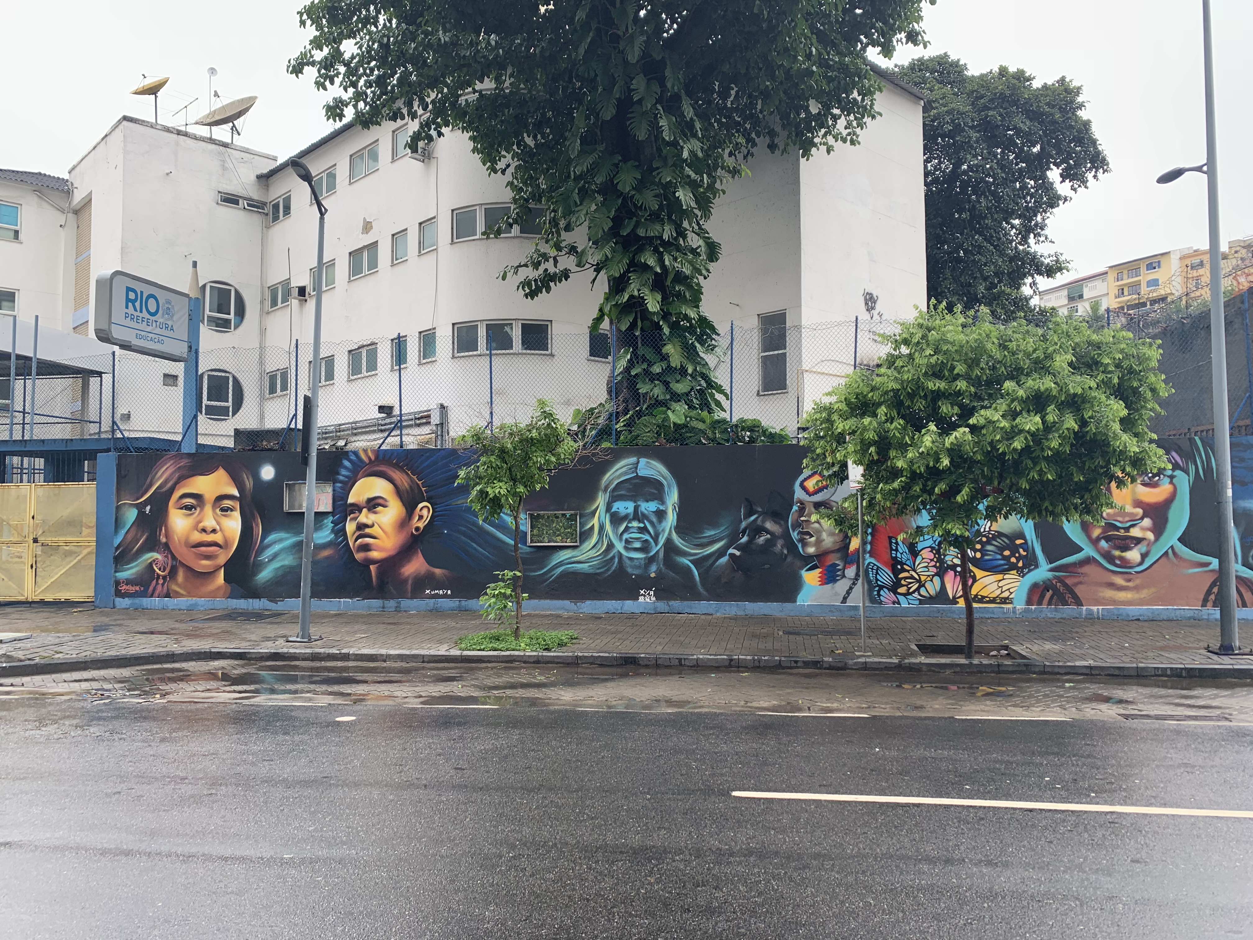 Large street mural of indigenous faces in downtown Rio de Janeiro