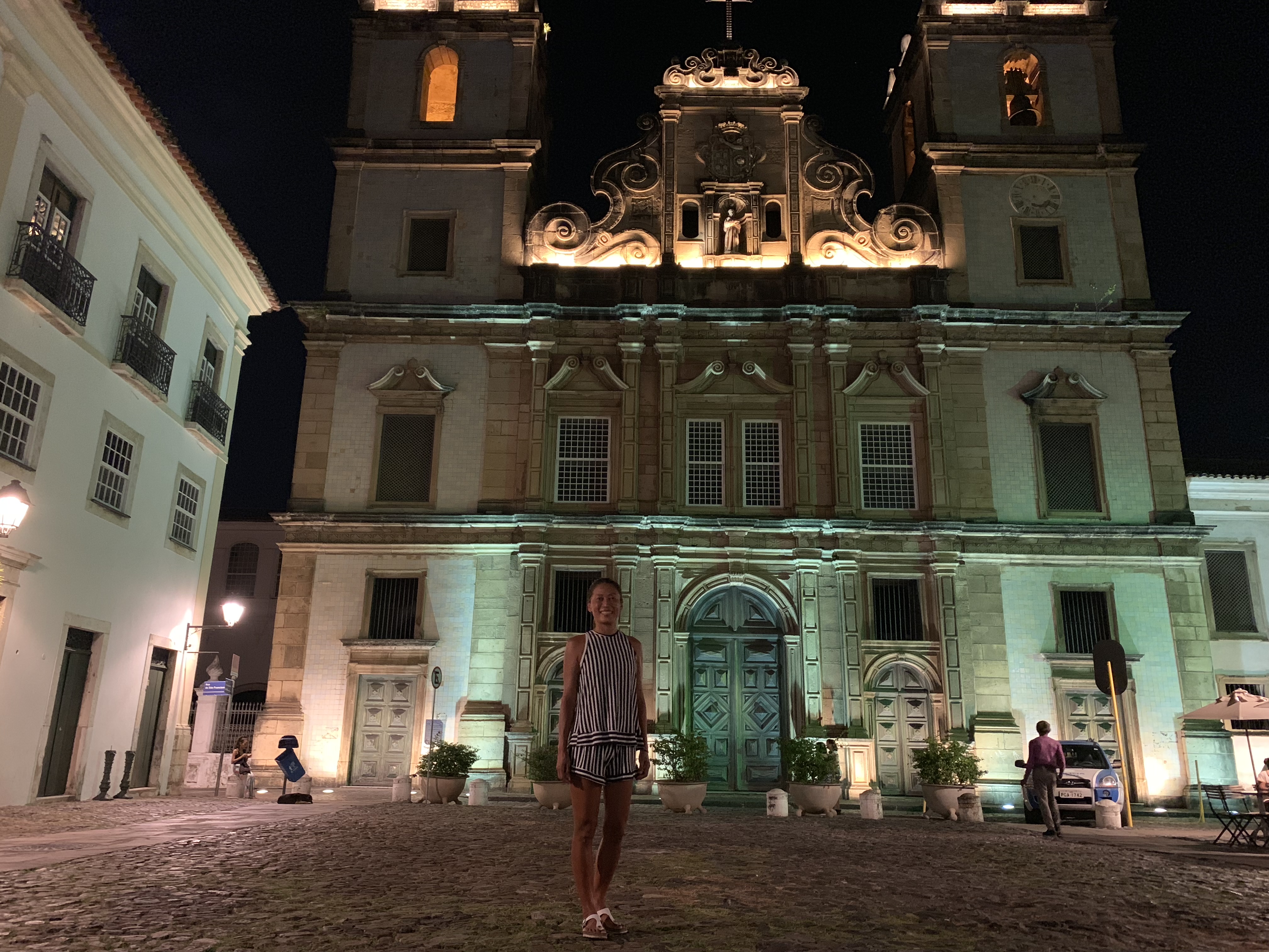 Yuka in front of a baroque church in Pelourinho at night
