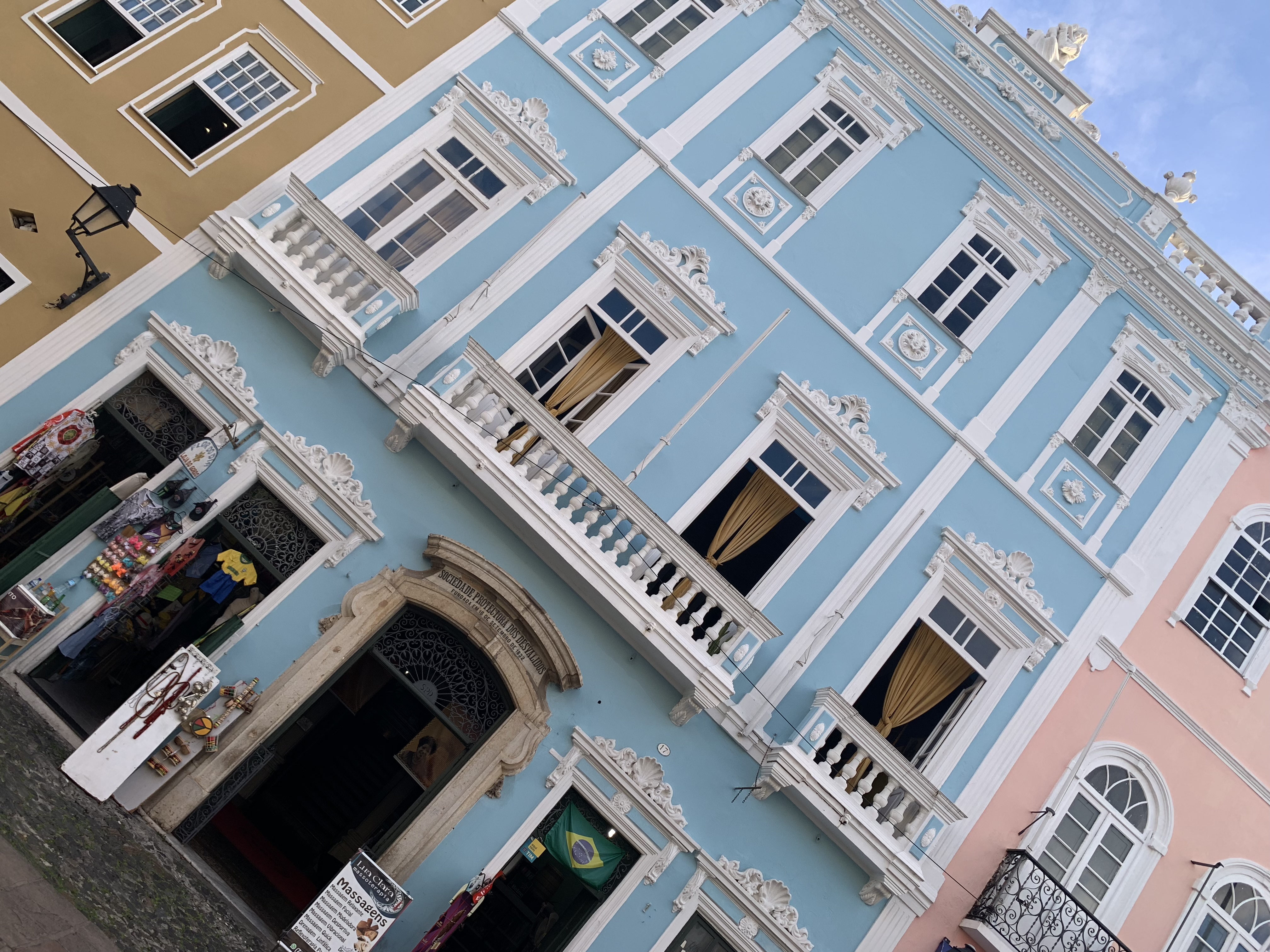 A blue colonial building facade seen from below