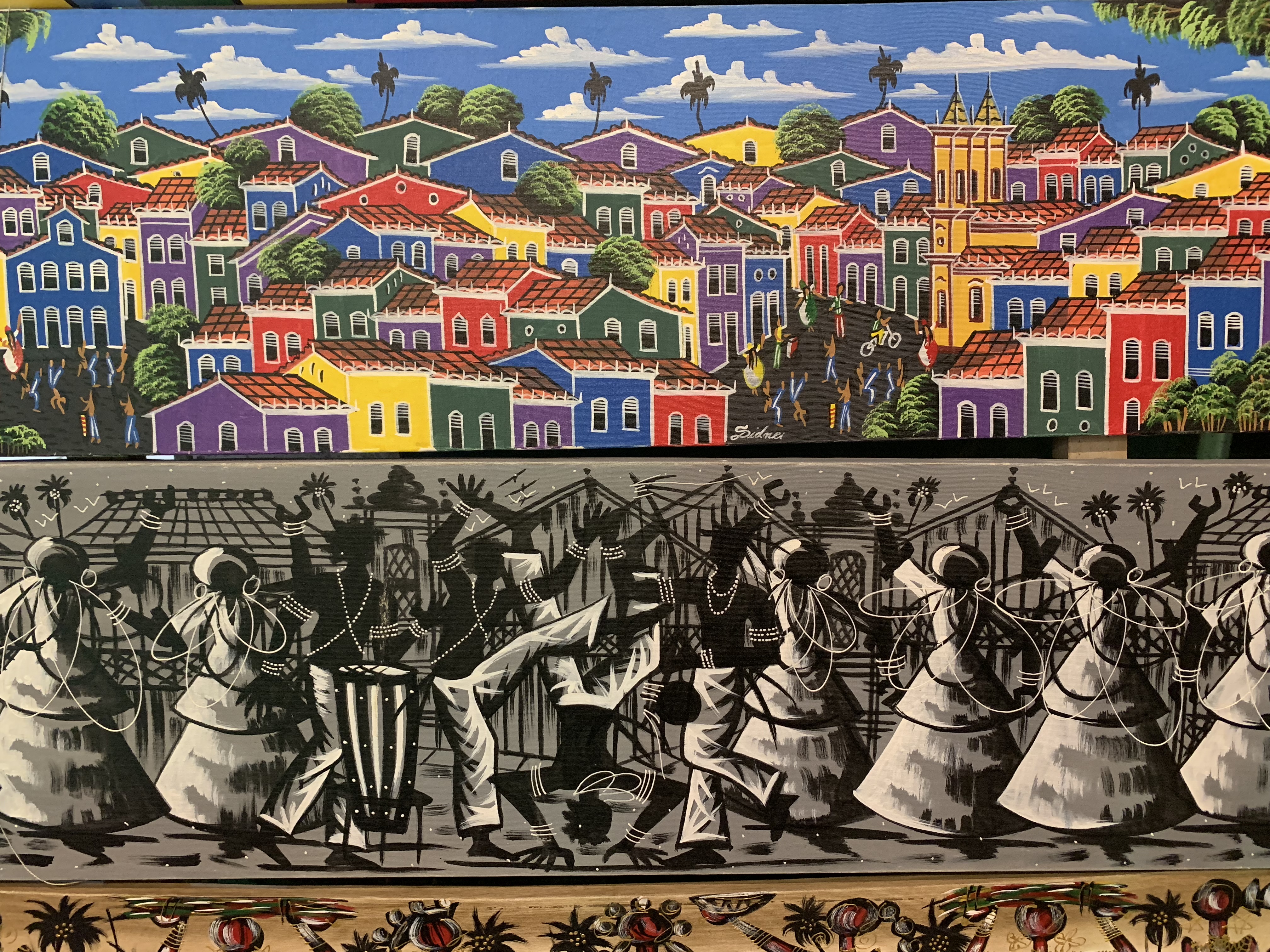 Two naïve art canvases — Pelourinho scene and capoeira silhouettes