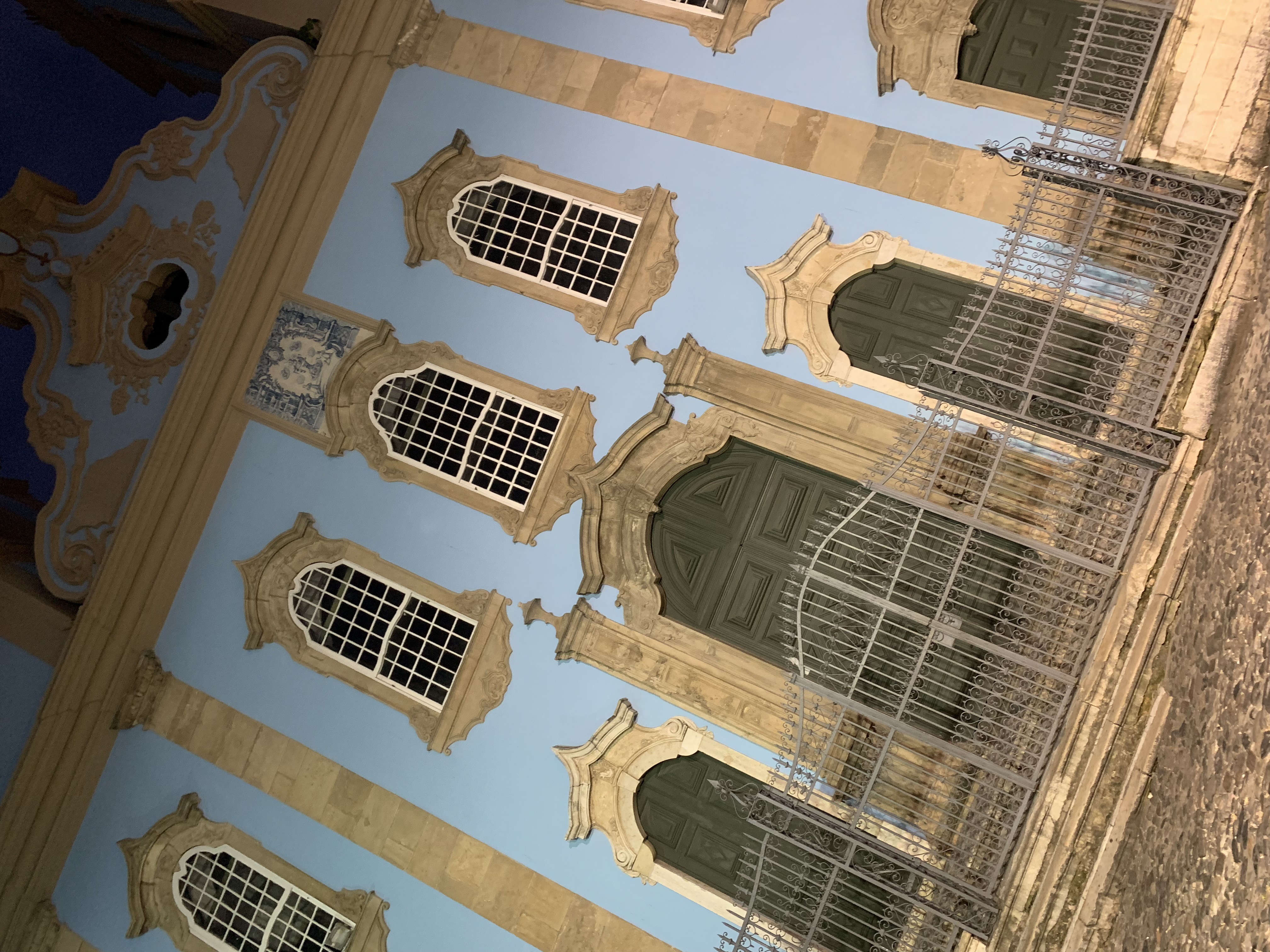A baroque church under scaffolding at night looking up