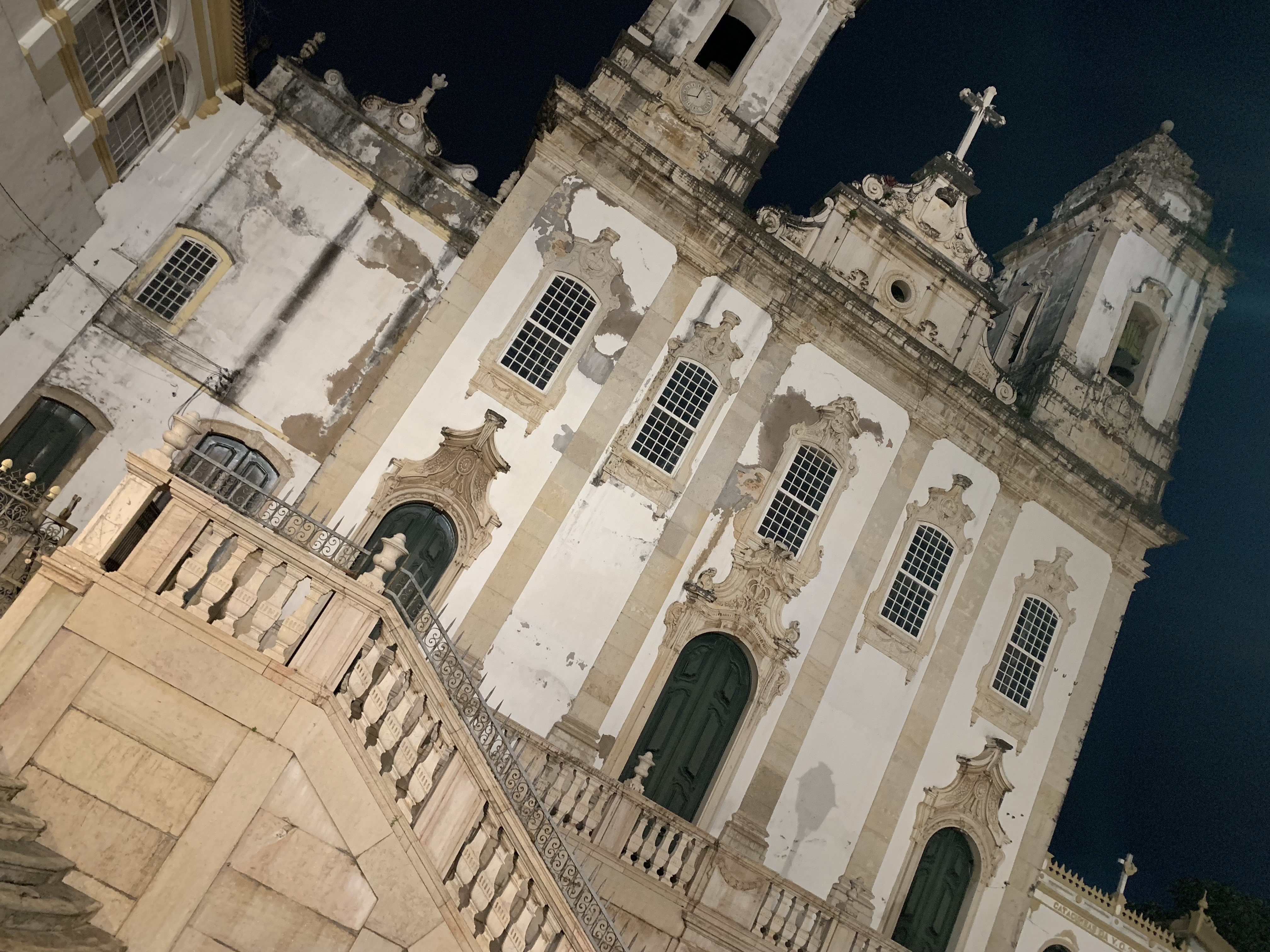 A white baroque church at night worm's-eye view