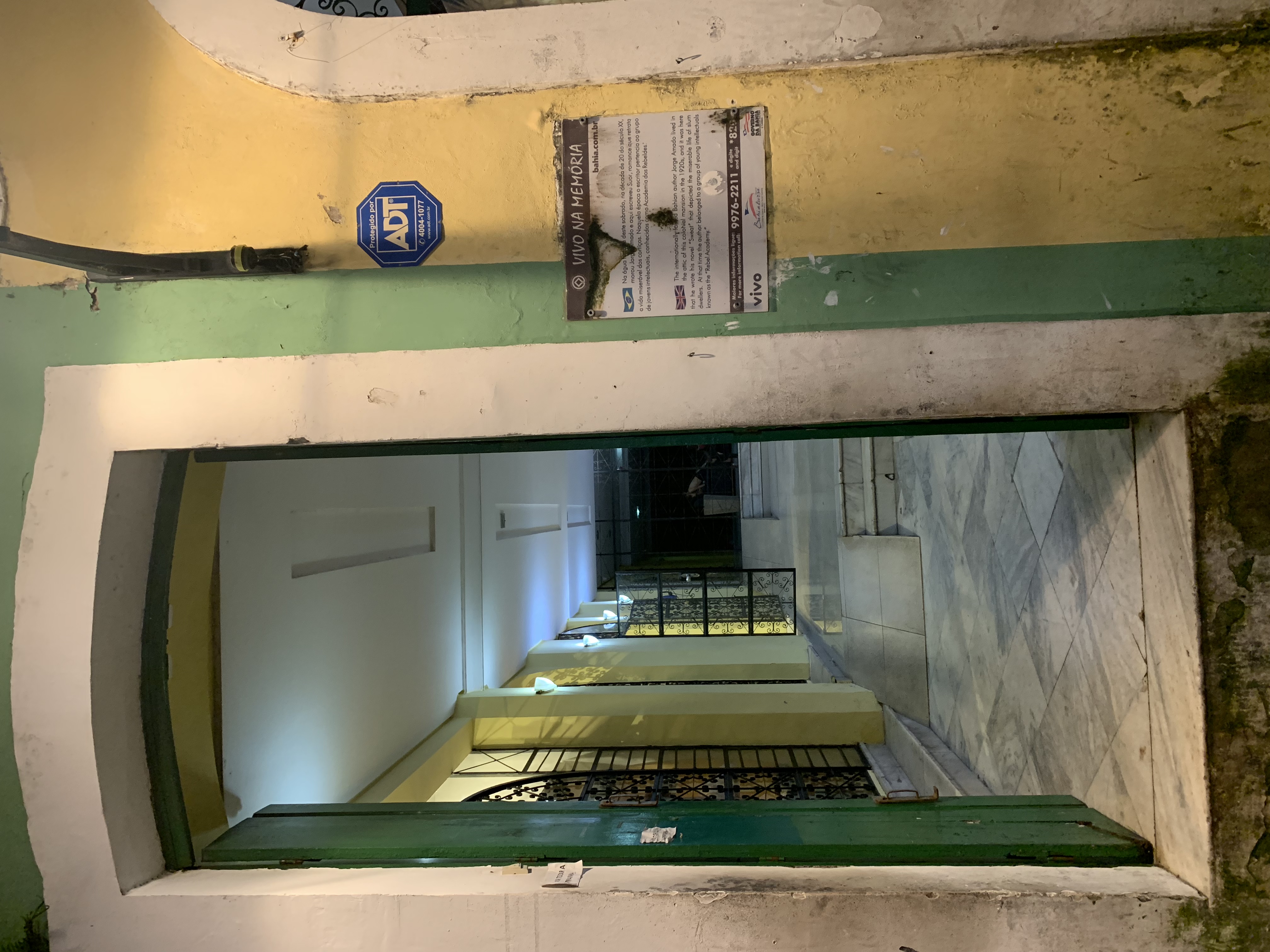 Looking down through a narrow arched colonial stairwell