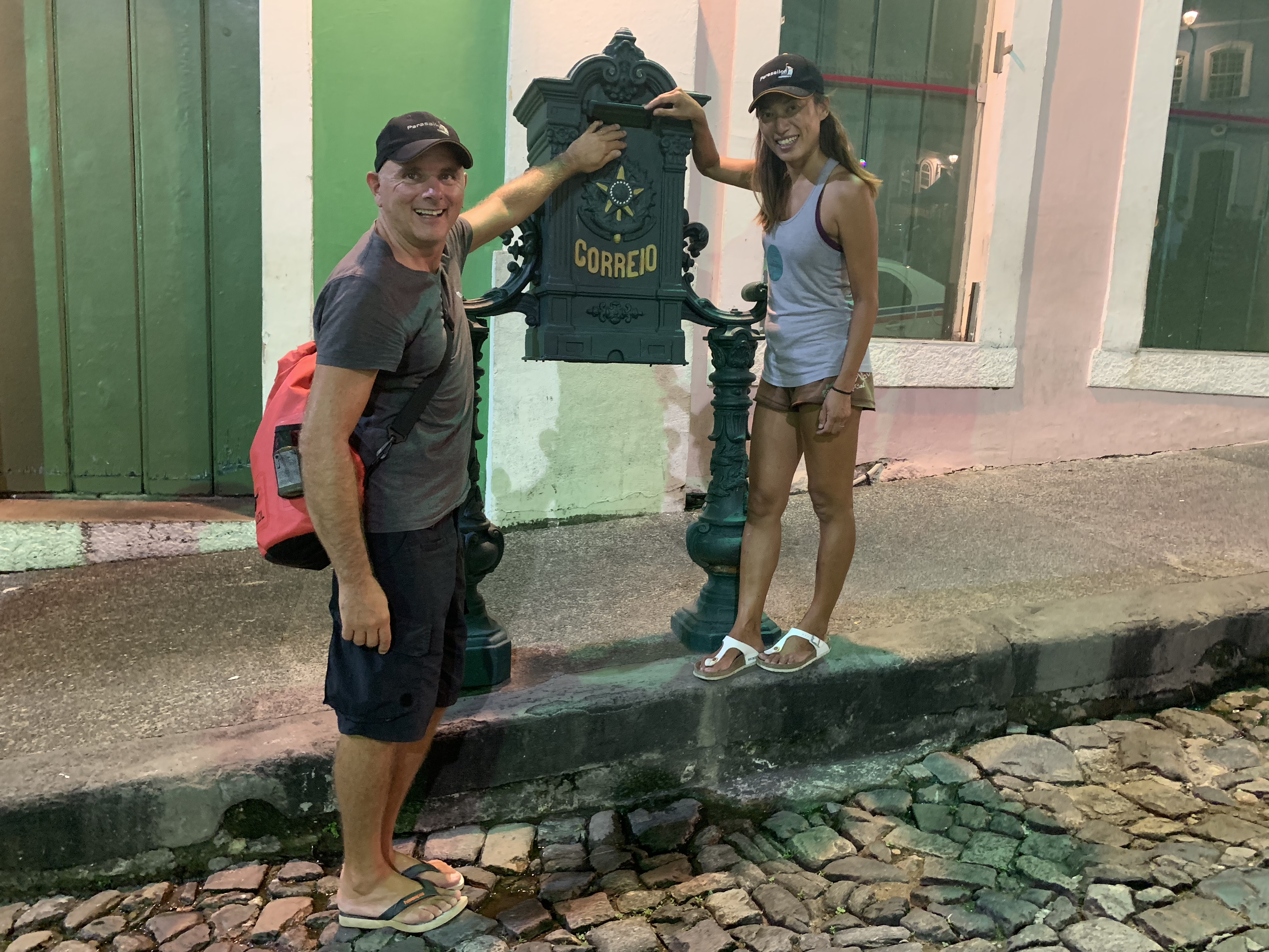 Francesco and Yuka posing with the antique green Correio post box at night