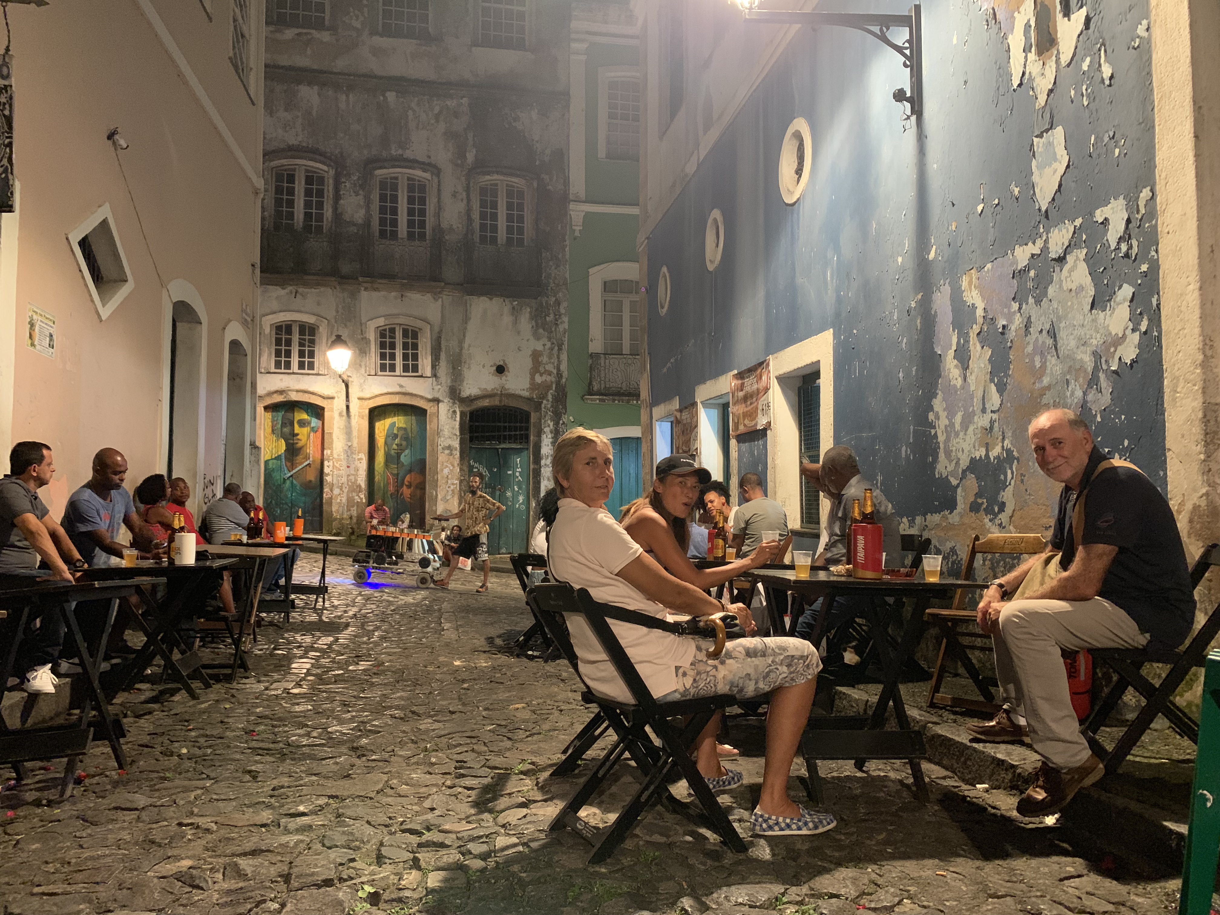 Outdoor restaurant in a Pelourinho alley at night Yuka seated