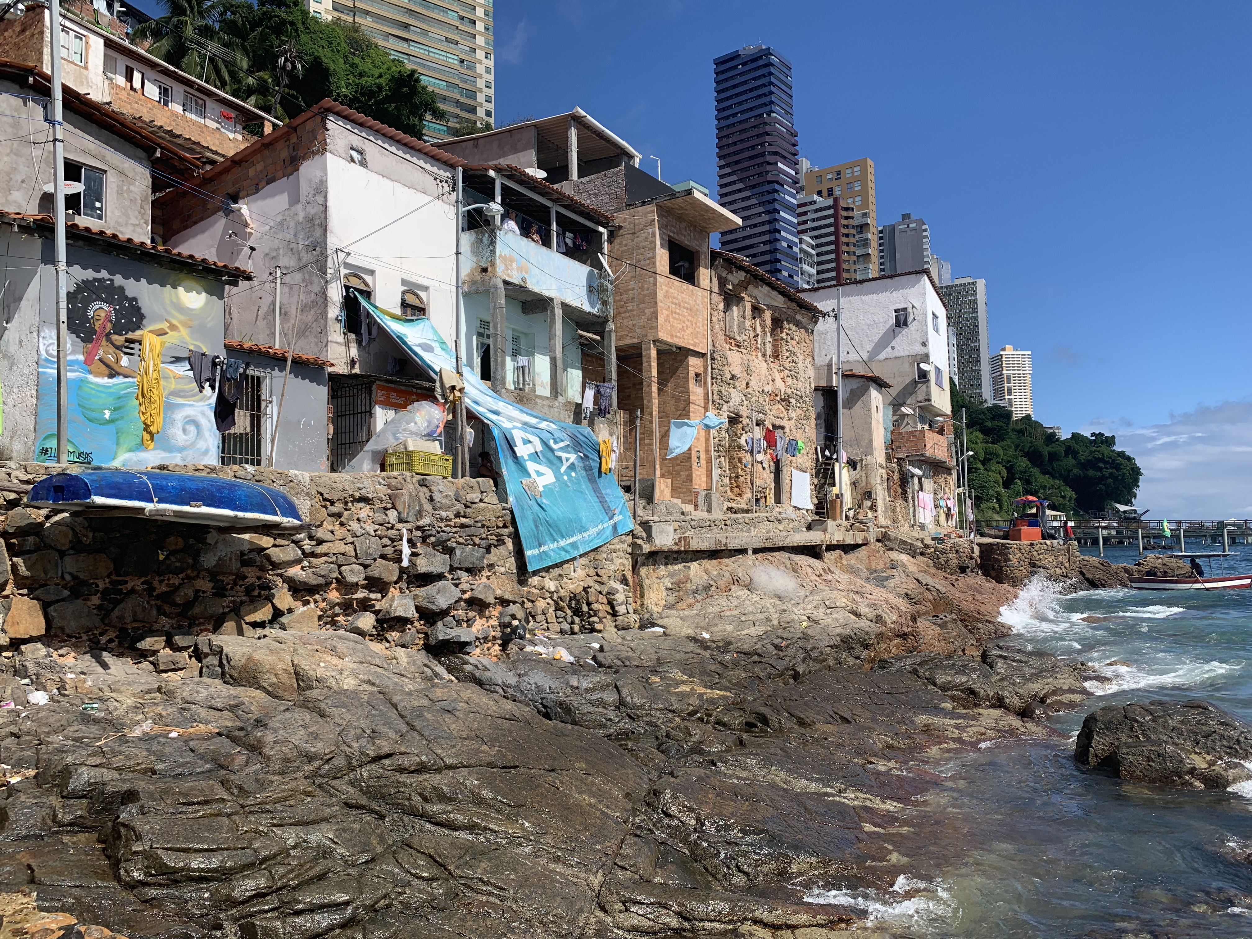 Fishing village waterfront homes with murals on the rocky coast