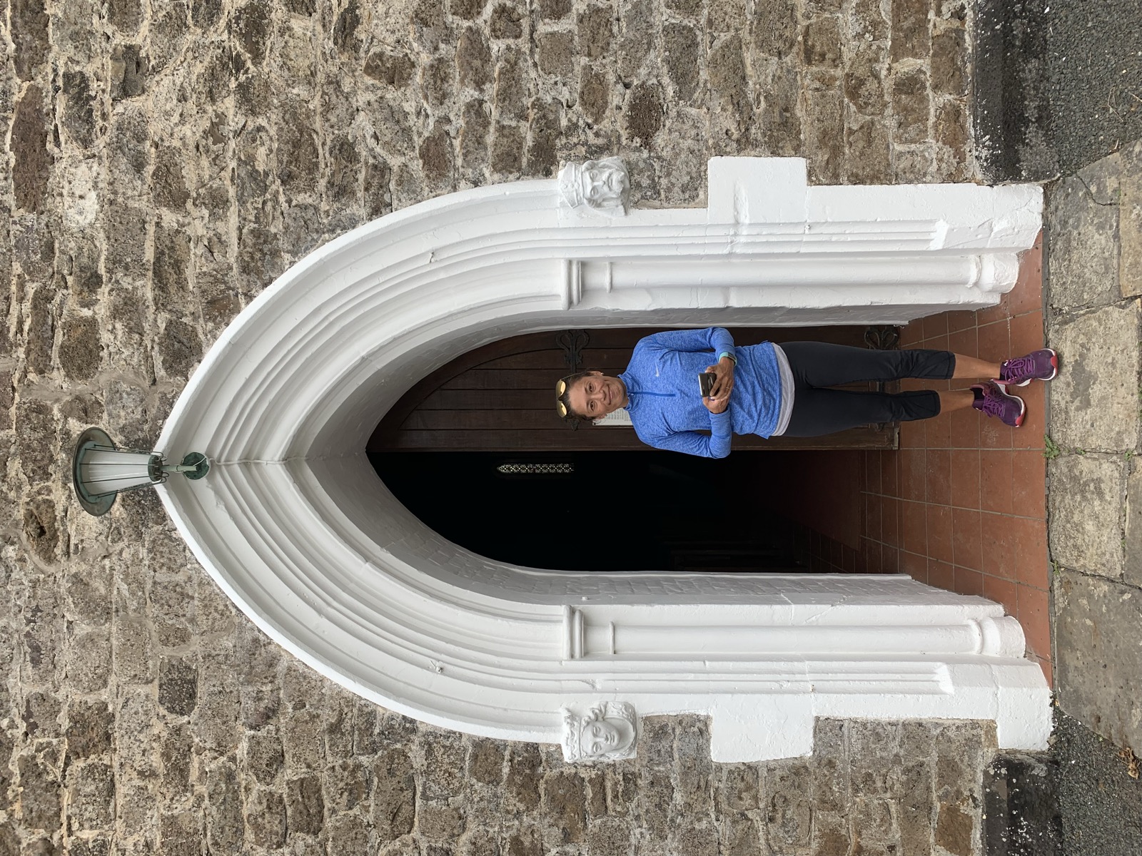 Yuka in the white arched doorway of a small church high in the St Helena highlands
