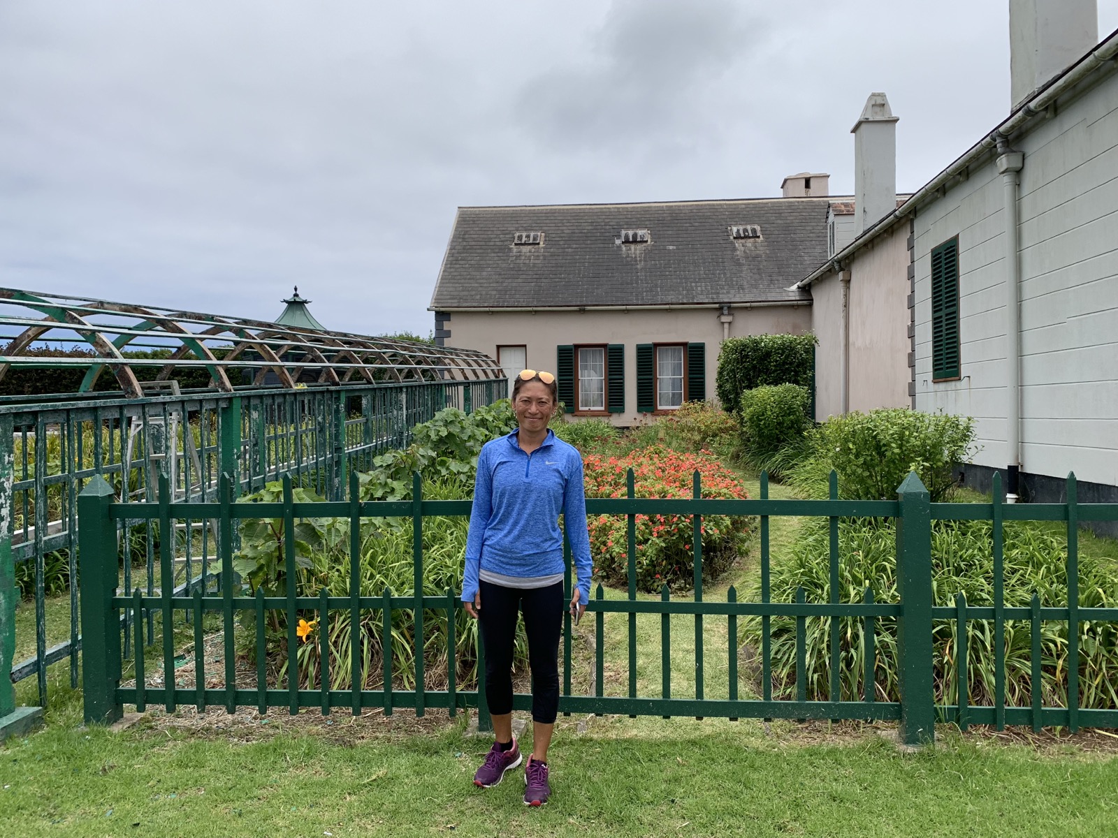 Yuka in front of Longwood House — the white building with green shutters and garden where Napoleon spent his exile