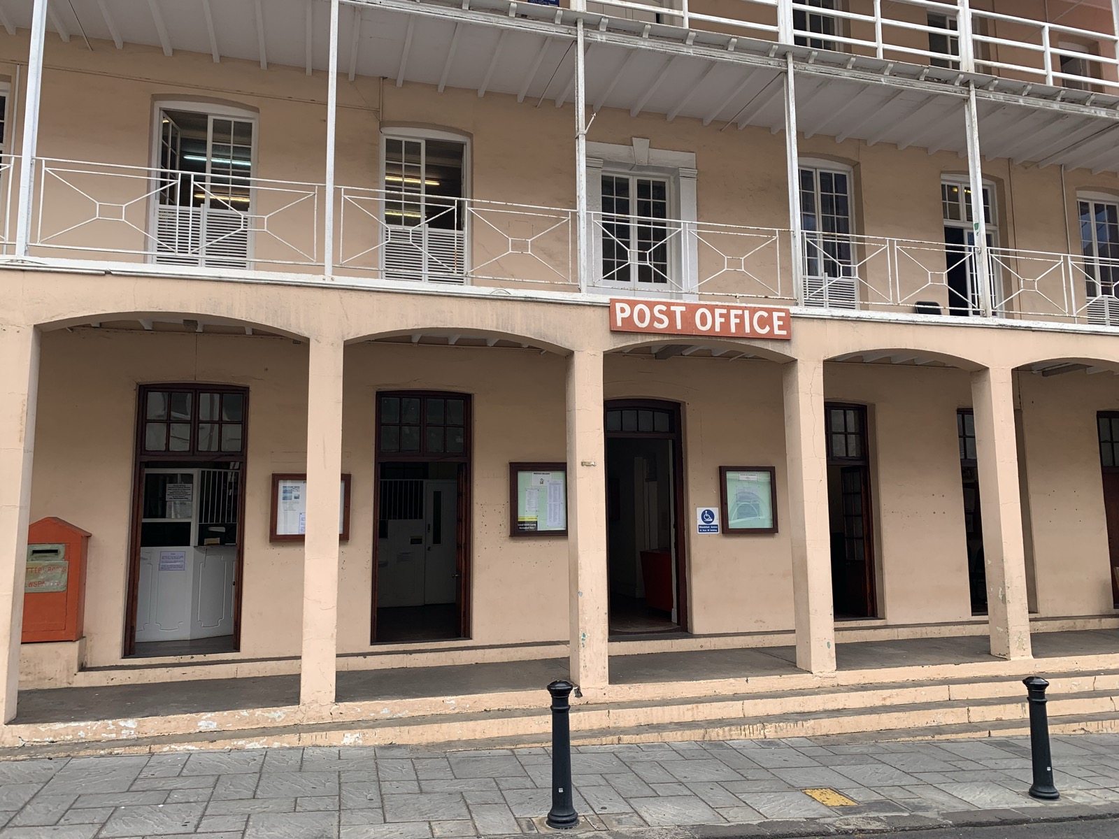 The Jamestown Post Office — a colonial peach-coloured building with arched arcade on the ground floor and iron-railed balcony above