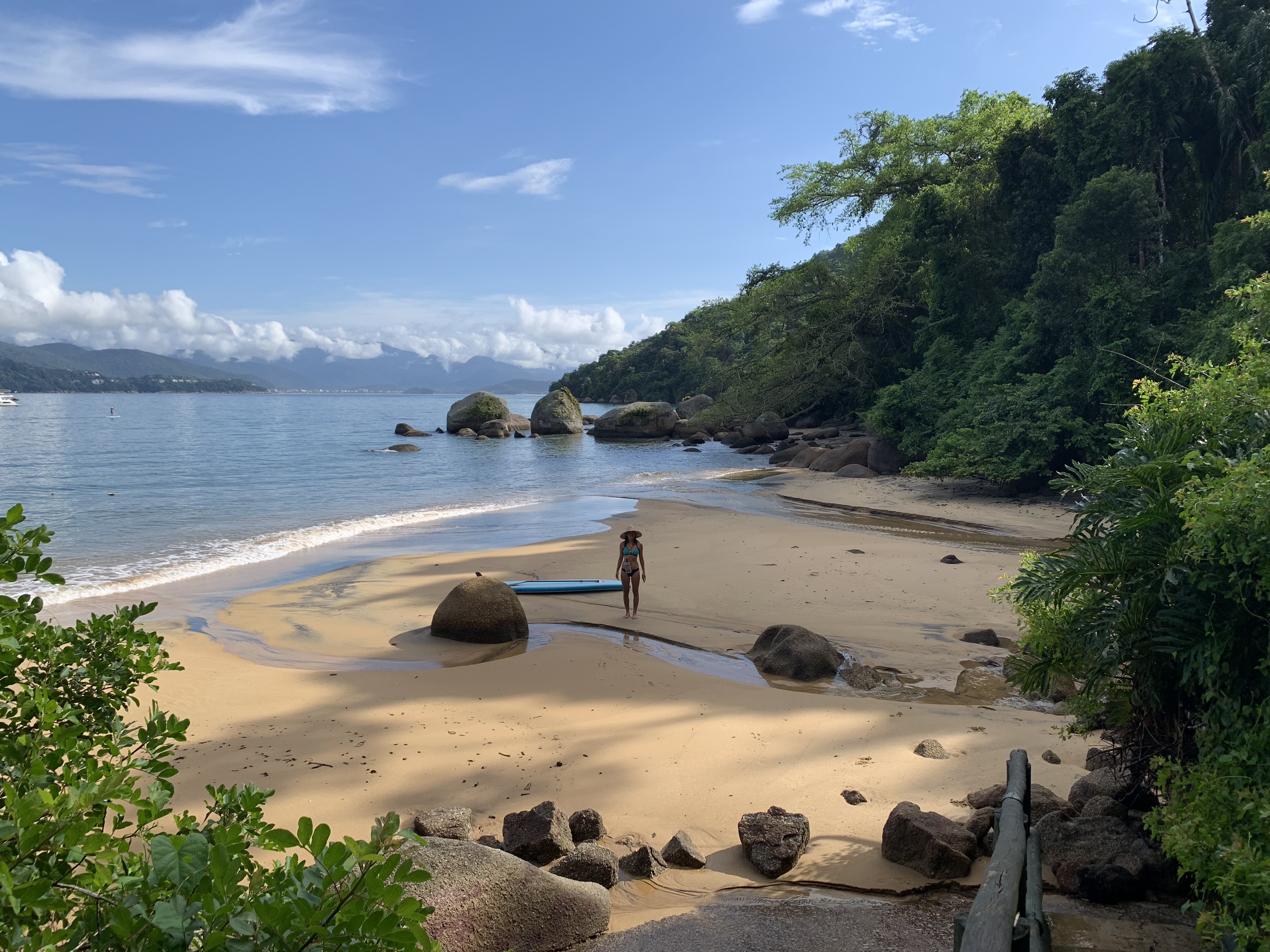 Yuka on the beach at Ilha Anchieta with SUP board