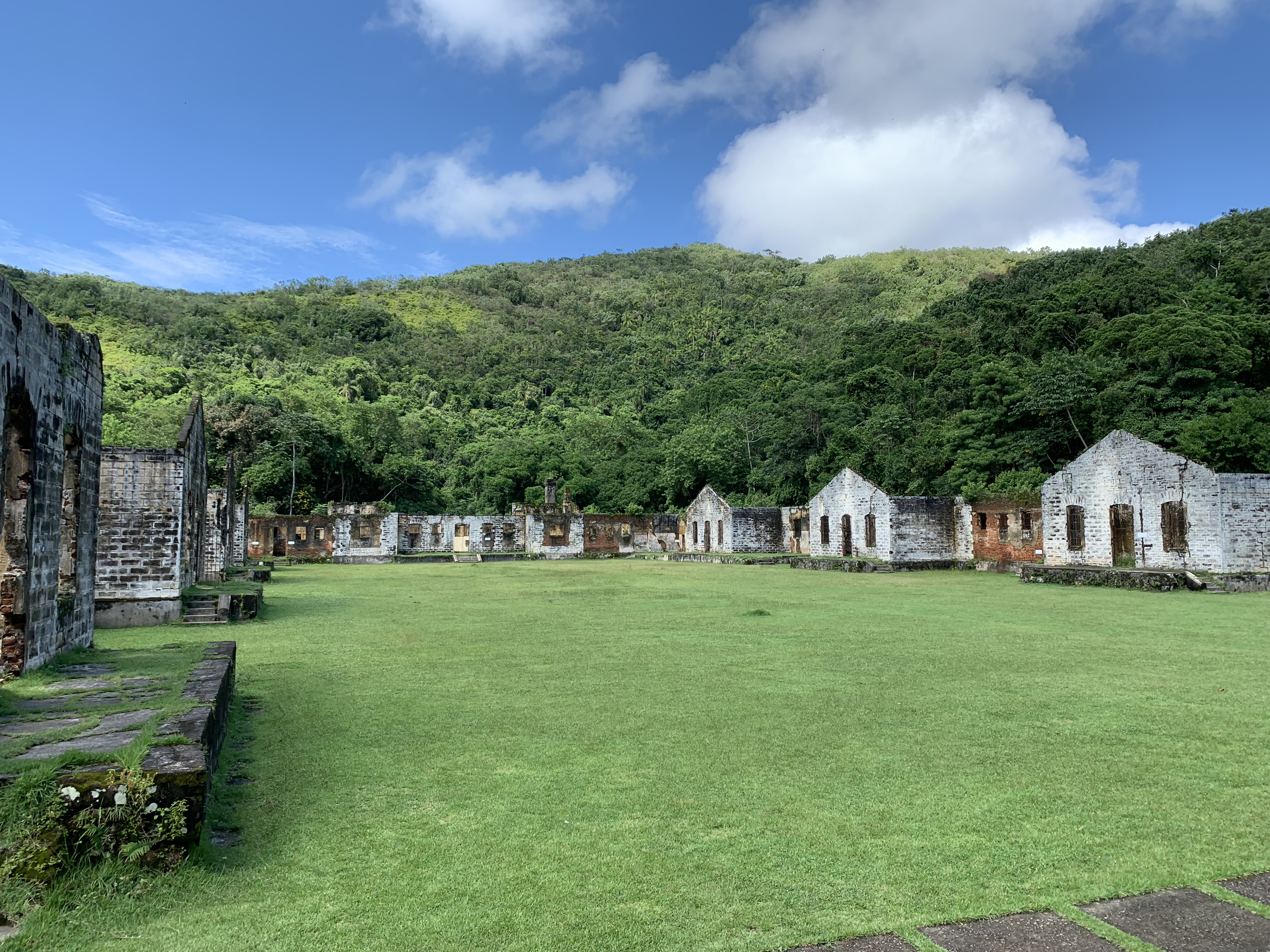 The prison courtyard at Ilha Anchieta, ruins of cell blocks with jungle behind
