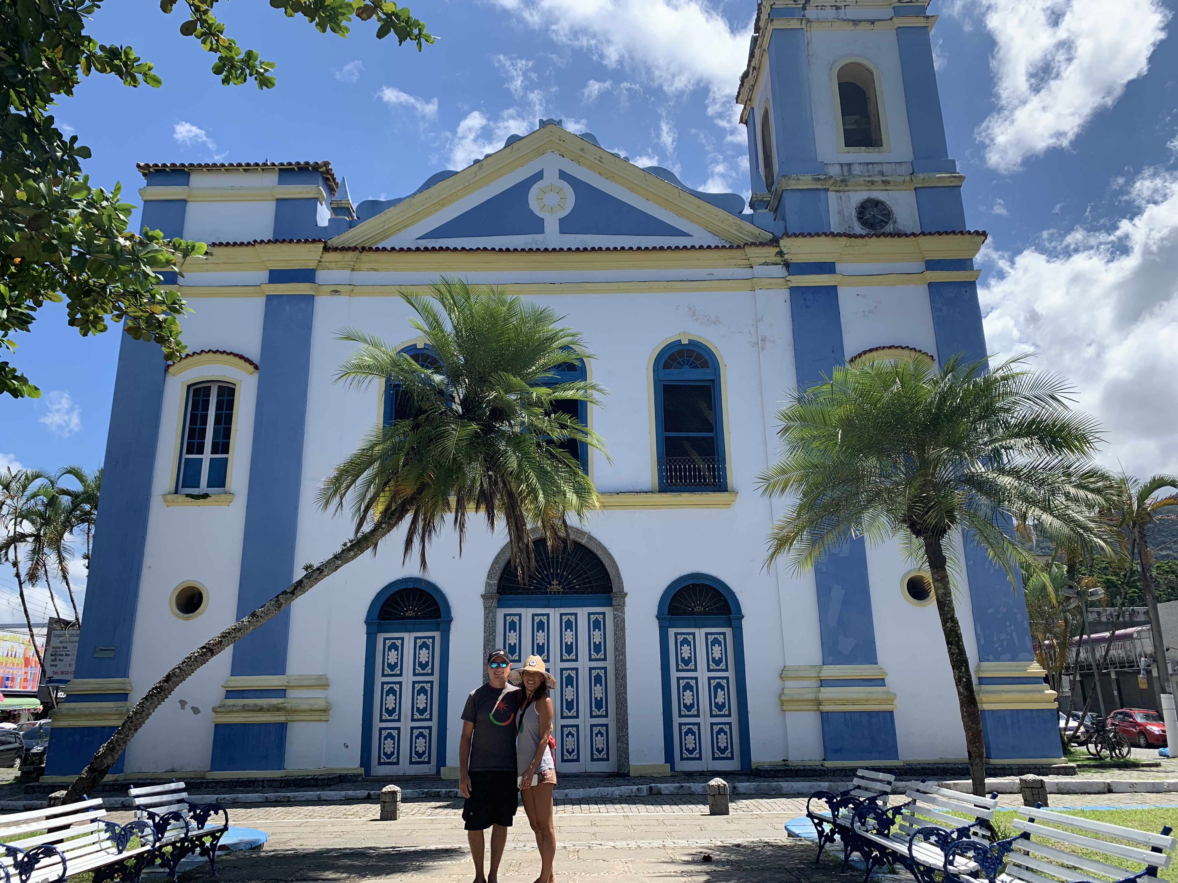 Francesco and Yuka in front of the blue colonial church in Ubatuba